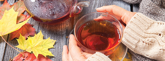 Autumn Still Life: Tea on maple leaves on a wooden table